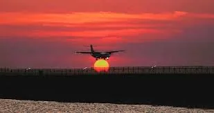 Airplane landing at sunset