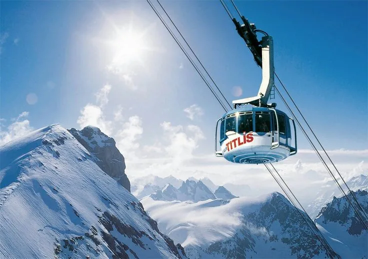Cable car above snowy mountains