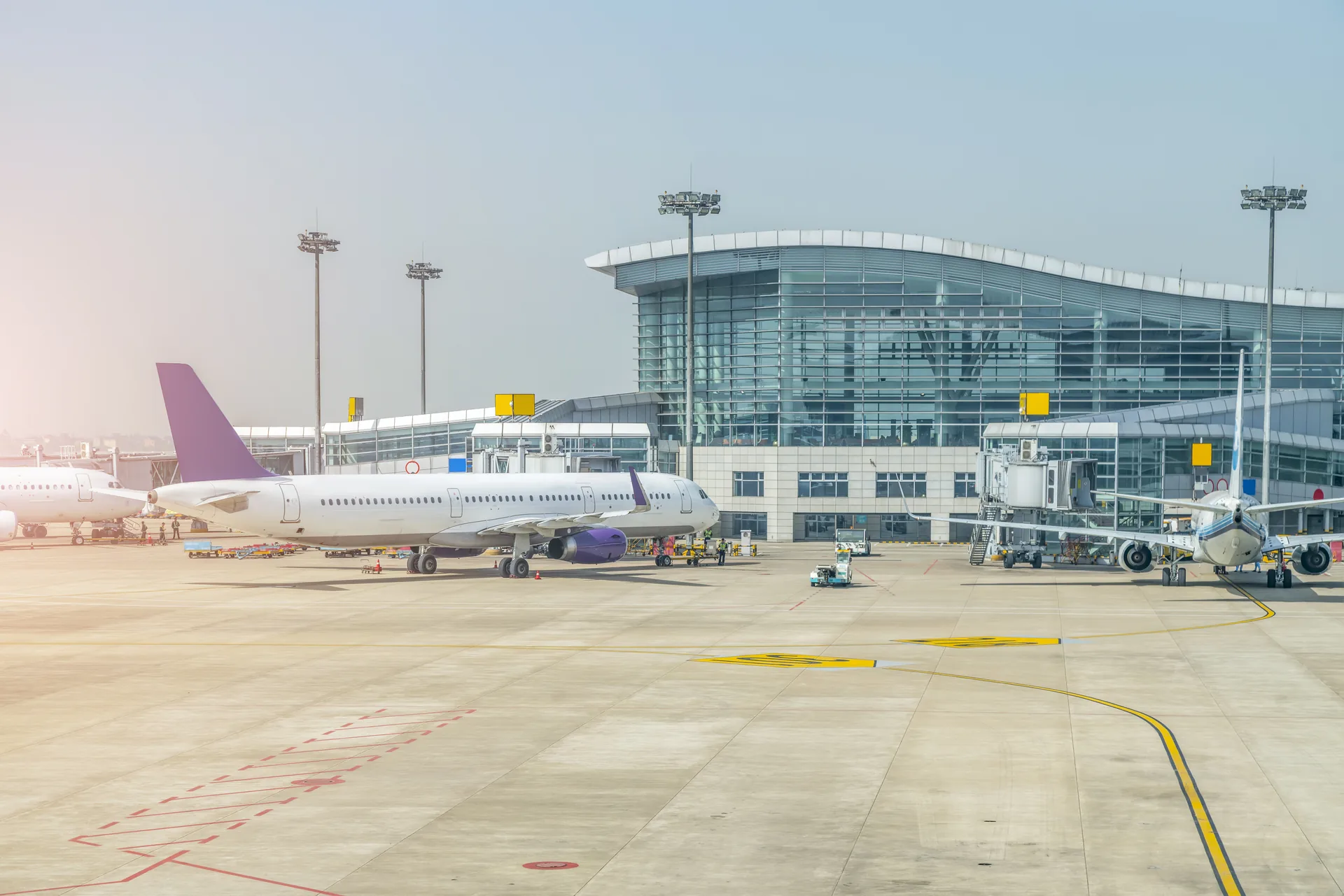 Glass airport terminal and parked aircraft