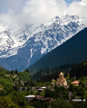 Mountain village beneath snowy peaks