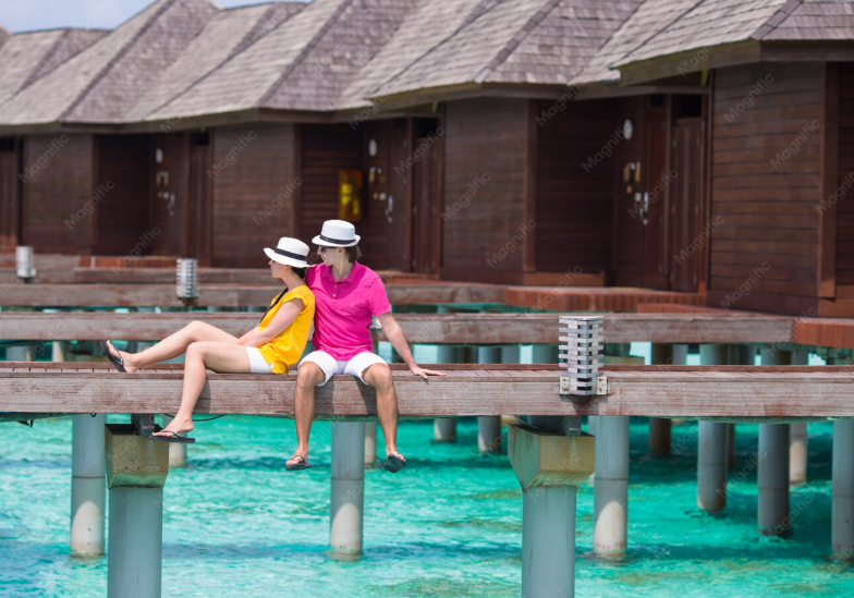 Travellers beside an overwater villa
